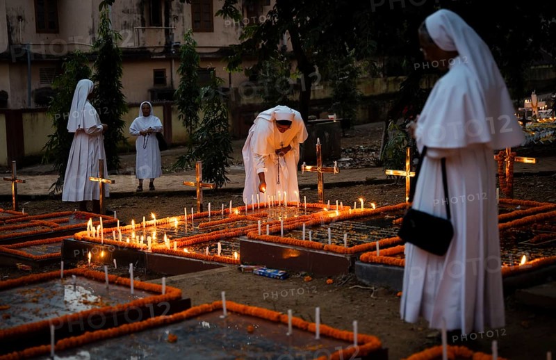 Nuns offer prayers on the grave during the All souls day observation, in Guwahati, India on 2 November 2024. All Souls' Day is a Christian holiday dedicated to honoring and praying for the souls of the departed