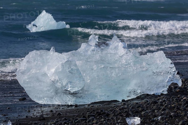 Little icebergs and crushed ice on the black beach at Joekulsarlon glacial lake