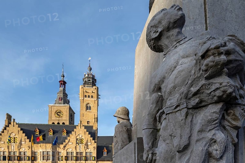 Detail of statue Jacques de Dixmude showing African slave on Market square with town hall and belfy in the city Diksmuide, West Flanders, Belgium, Europe