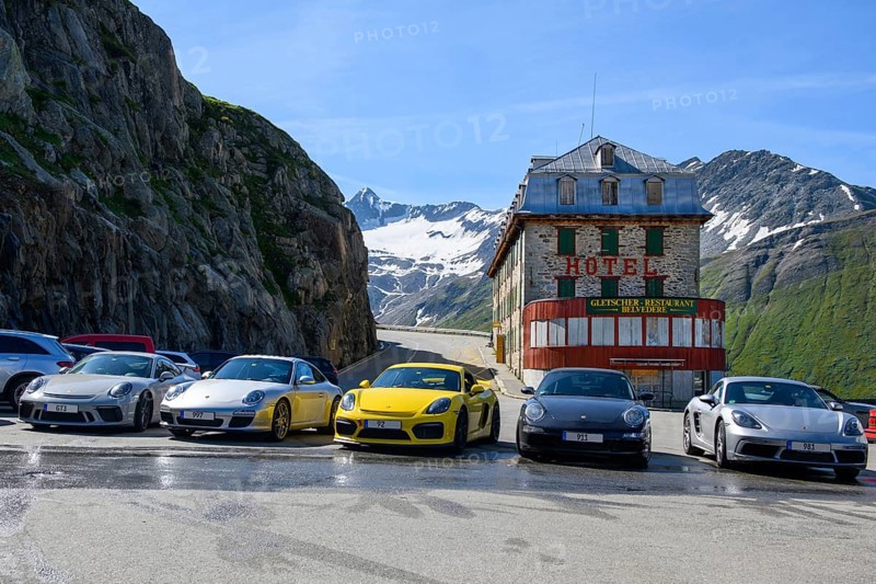 Five 5 Porsche sports cars parked in front of historic abandoned former now closed Hotel Gletscher-Restaurant Belvedere on Furka pass road mountain road alpine pass Furka Pass, Alps, Canton Valais, Switzerland, Europe