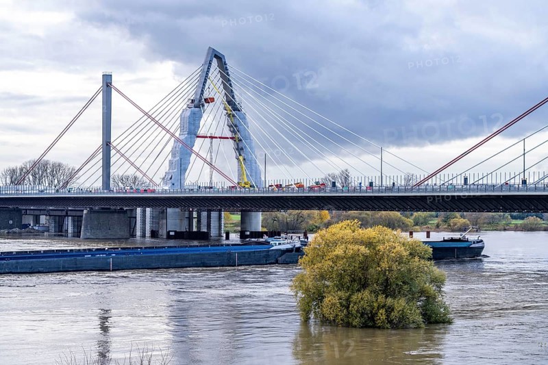 New construction of the A1 motorway bridge over the Rhine near Leverkusen, after completion of the new bridge, the old one in front will be demolished and another one, for a total of 8 lanes, will be rebuilt at the same place, cargo ship, flood, Leverkusen, North Rhine-Westphalia, Germany, Europe