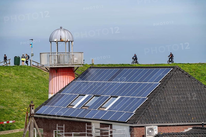 Solar modules on roofs, on the roof of a building on the dyke, North Sea coast, in Zeeland, Westkapelle, Netherlands