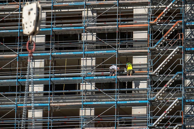 Construction site, at the Cologne Trade Fair Centre, new construction of a high-rise office building, construction cranes, facade of the shell, scaffolding, construction crane, North Rhine-Westphalia, Germany, Europe