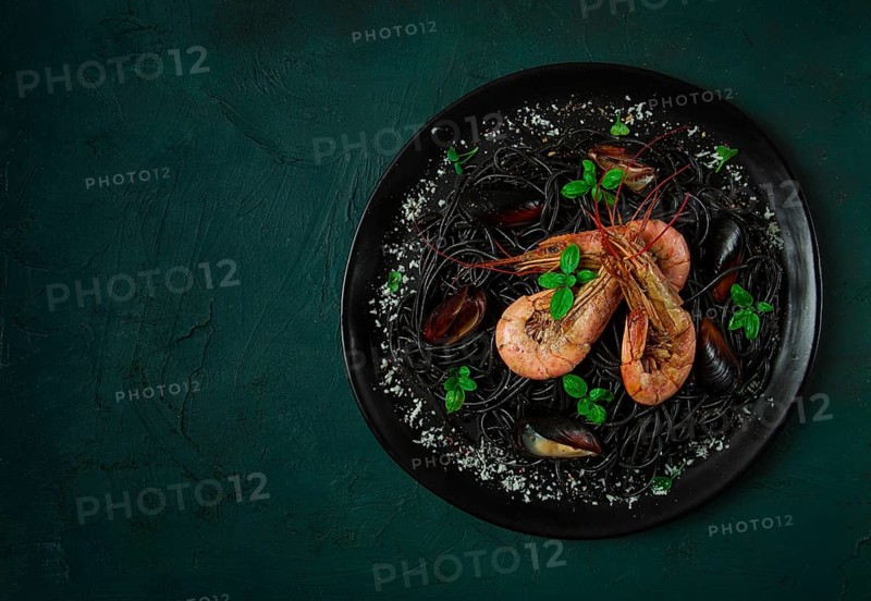Black pasta with seafood, spaghetti with shrimp and mussels, top view, homemade, no people