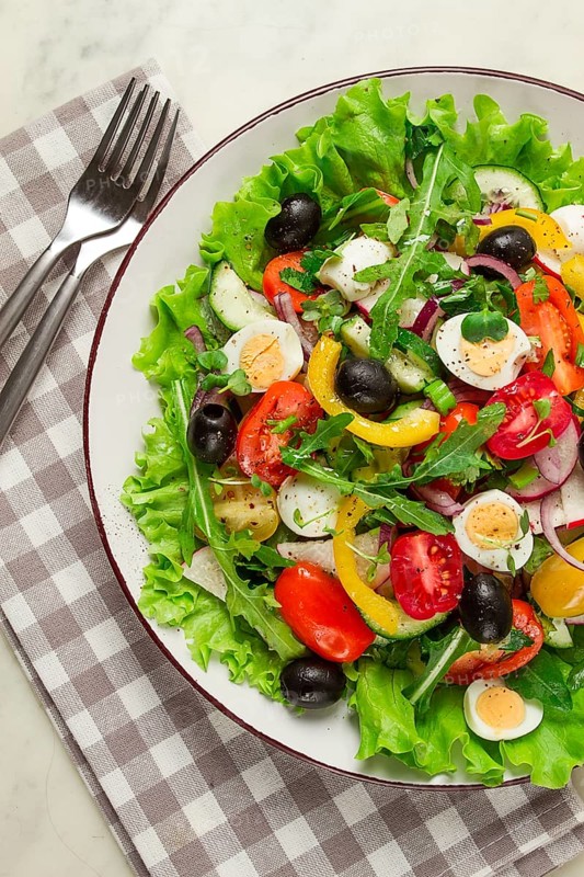 Vegetable salad, with quail eggs and olives, fresh, close-up, no people
