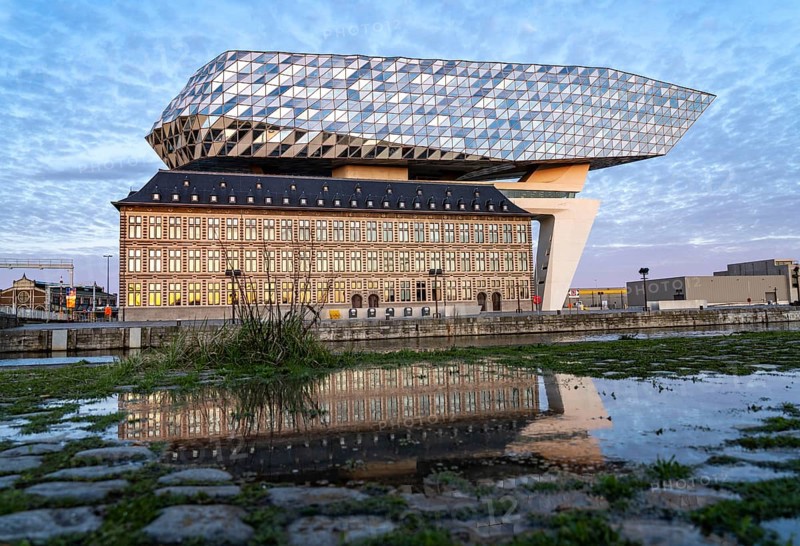 The Antwerp Port Authority building, Havenhuis, former fire brigade barracks in the harbour, renovated and with an attached glass structure in the shape of a ship's hull, administrative headquarters of the Antwerp Port Authority, designed by Zaha Hadid, Antwerp, Flanders, Belgium, Europe