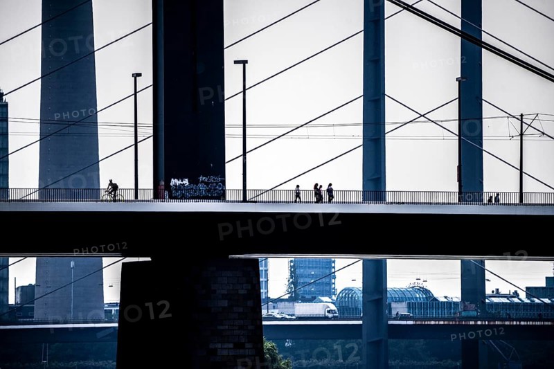 Oberkassler bridge over the Rhine near Düsseldorf, in front, behind the Rheinknie bridge, cyclist, North Rhine-Westphalia, Germany, Europe