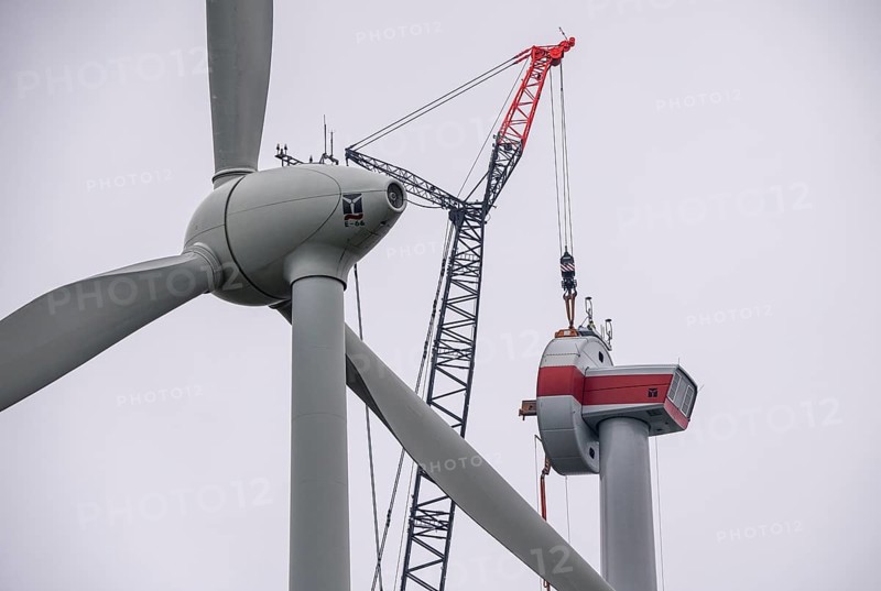 Erection of a wind turbine, wind energy plant, assembly of the ring generator, with a crawler lattice crane, wind farm near Hagen, North Rhine-Westphalia, Germany, Europe