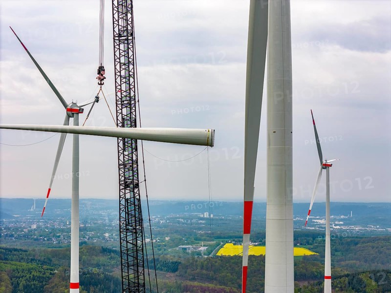 Erection of a wind turbine, wind energy plant, assembly of the third blade, with a crawler lattice crane, wind farm near Hagen, North Rhine-Westphalia, Germany, Europe