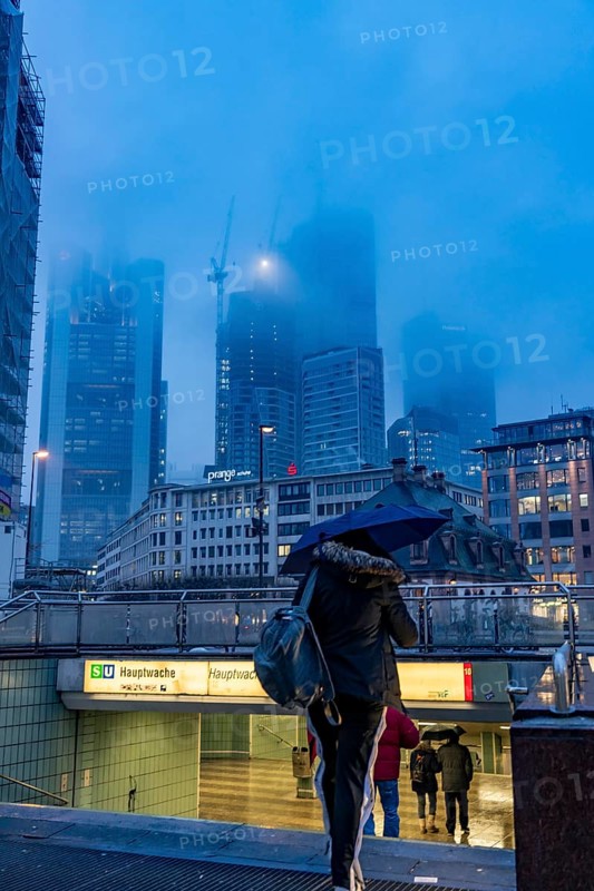 Rainy weather, freezing rain, entrance to Hauptwache underground station, high-rise skyline in clouds, passers-by hurrying through the damp, icy weather, Frankfurt am Main, Hesse, Germany, Europe