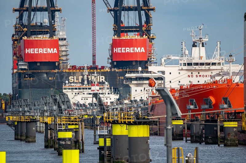 Petroleum harbour, tankers waiting for new loads in Europoort harbour, in the background the world's largest floating crane, Heerema Sleipnir, from Rotterdam, Netherlands