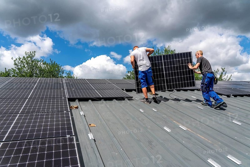 Installation of solar modules on the roof of a barn on a farm, over 210 photovoltaic modules are installed on the roof, North Rhine-Westphalia, Germany, Europe