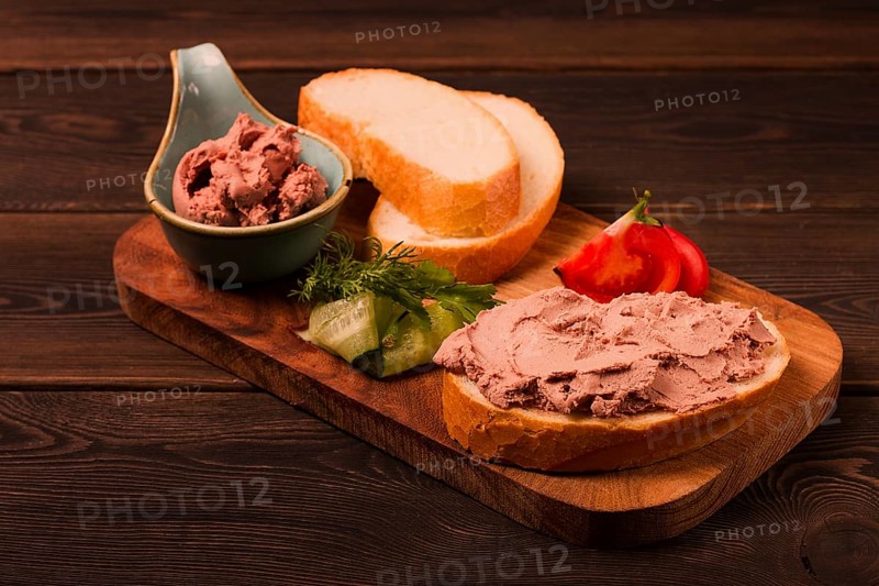 Liver meat pate spread, on white bread, on a wooden background, breakfast, close-up, no people, selective focus, pasticcio, pastete