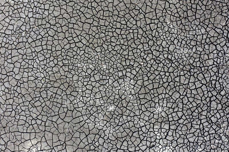 The bottom of a dried-up fish pond in Reckahn in Brandenburg looks like parched desert soil. The Plane, a river that usually fills the fish ponds with water, is dry and no longer carries any water, Reckahn, 09/08/2022