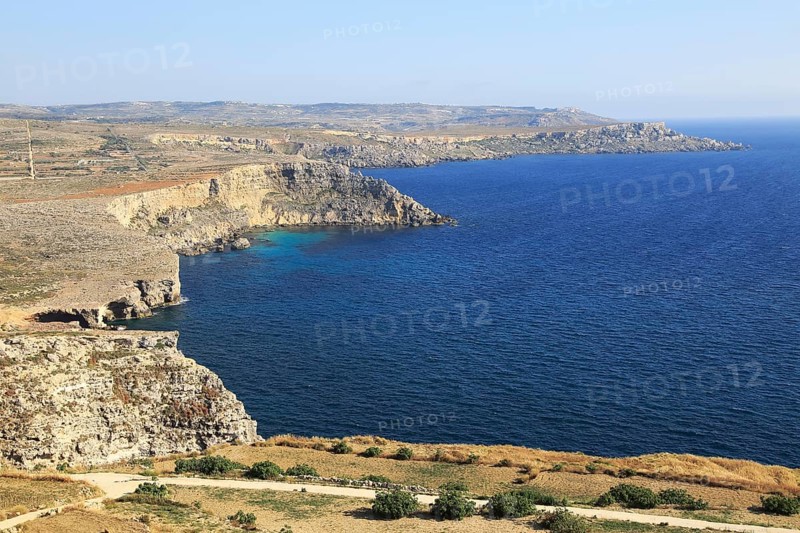 Coastal scenery of cliffs and blue sea looking south from Res il-Qammieh, Marfa Peninsula, Republic of Malta