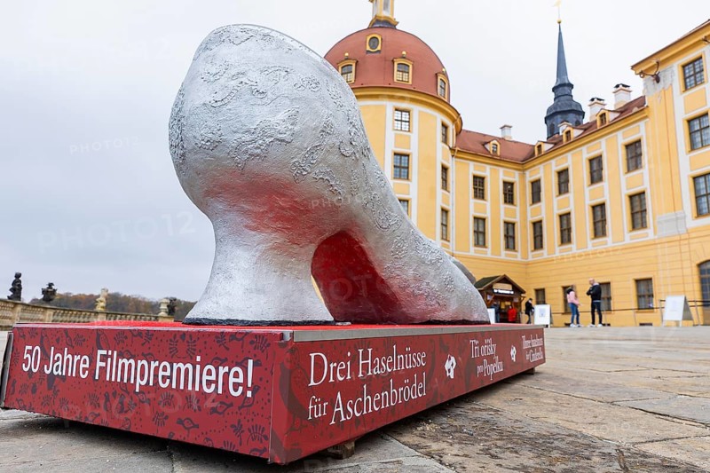 A giant Cinderella slipper welcomes visitors to the exhibition. This year, the most popular fairytale film of all time is celebrating a special anniversary. At Moritzburg Castle, one of the film's locations, the exhibition on the cult film Three Hazelnuts for Cinderella opens for the twelfth time - with an anniversary-worthy supporting programme and special exhibition, Moritzburg, Saxony, Germany, Europe