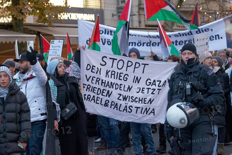 Demonstrators with banner Stop the war in Gaza, peace between Israel and Palestine, Pro Palestine demonstration on 2 December 2023 in Düsseldorf, North Rhine-Westphalia, Germany, Europe