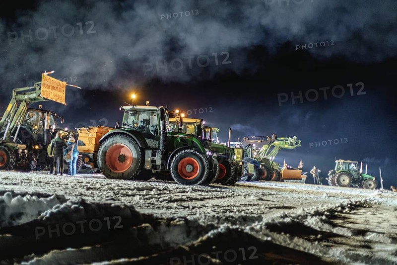 Tractors during a rally as part of the farmers' protests on the snow-covered Kirchbichl, Schliersee, Upper Bavaria, Bavaria, Germany, Europe