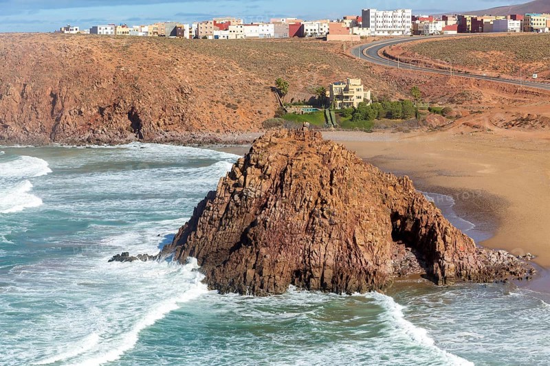 Beach rocky outrcop coastline in bay, Plage Sidi Mohammed Ben Abdellah, Mirleft, Morocco, north Africa, Africa
