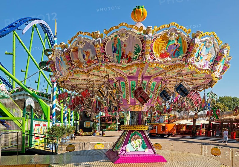 Empty children's carousel under a blue sky in the morning, Cranger Kirmes, Herne, Ruhr area, North Rhine-Westphalia, Germany, Europe