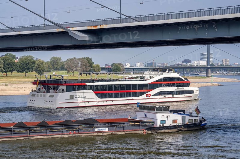 Shipping traffic on the Rhine near Düsseldorf, KD Schiff Rhein Galaxie, excursion ship, party ship, freighter Christa, loaded with coal for power stations, Rheinkniebrücke, North Rhine-Westphalia, Germany, Europe