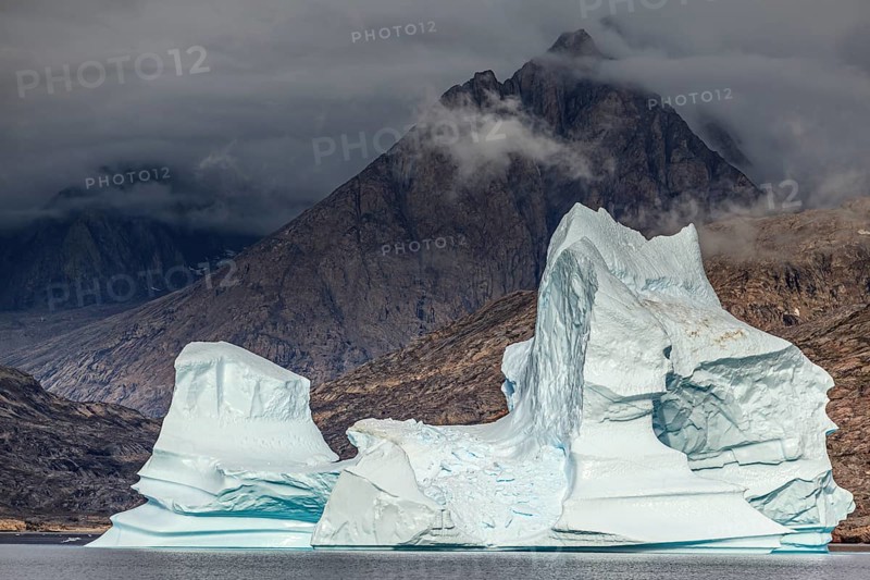 Large icebergs in fjord in front of steep mountains, cloudy mood, summer, Scoresby Sound, East Greenland, Greenland, North America