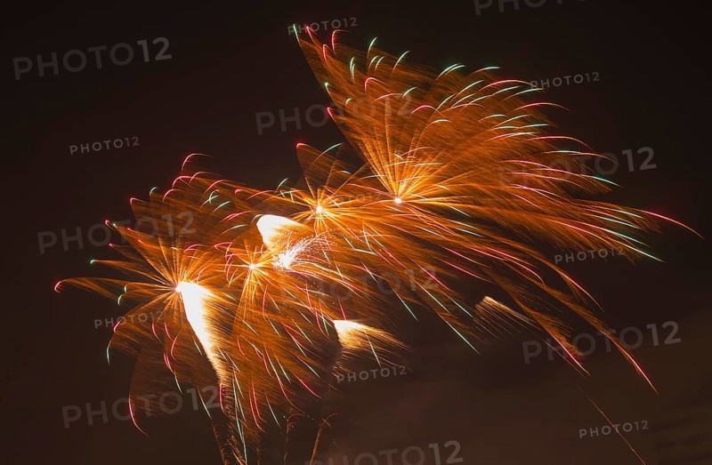 Colourful fireworks explode with colourful trails of light in the night sky, Lower Saxony, Germany, Europe
