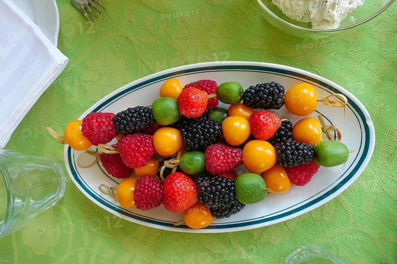Fruit skewers arranged on serving platter, raspberries, blackberries, kiwi, physalis, bladder cherries, healthy, vegetarian, fruit, vitamins, food, breakfast table, brunch, table setting, food, studio, Germany, Europe