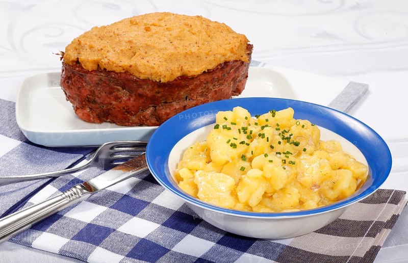 Swabian cuisine, Stuttgarter Leberkäs in a horseradish-mustard coating, Swabian potato salad, Leberkäse, meat loaf, mustard crust, grandmother's cooking, regional, home cooking, typical Swabian, traditional cuisine, serving platter, cutlery, food photography, studio, Germany, Europe