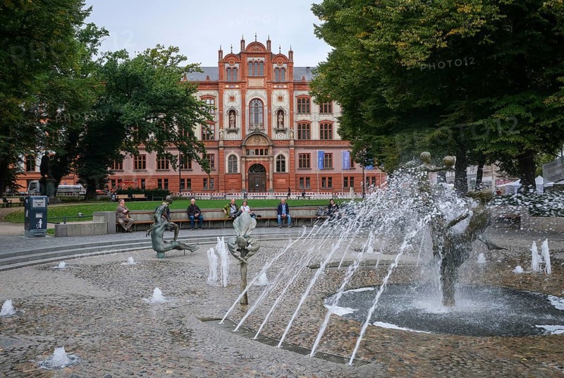 Rostock, Mecklenburg-Western Pomerania, Germany, University of Rostock, main building of the university on University Square, fountain of joie de vivre, pedestrian zone in the historic city centre. The University of Rostock was founded in 1419. The University of Rostock performs very well in national and international rankings. For example, the Institute of Physics is in the top group in the CHE ranking, Europe