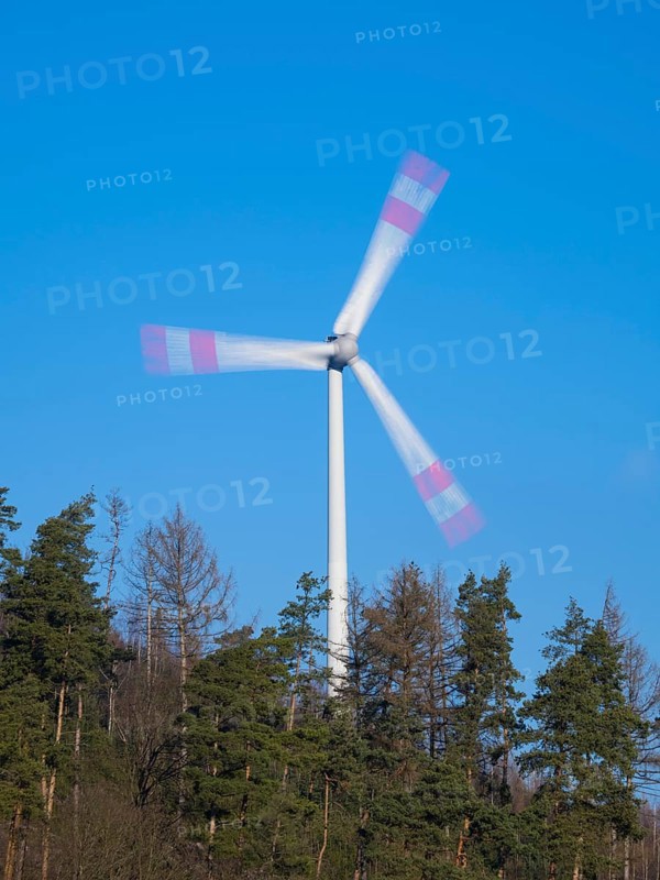 Wind Turbine, on a ridge in a forest, taken with a long exposure to create an abstract blurred effect of the rotary blades, North Hesse, Germany, Europe