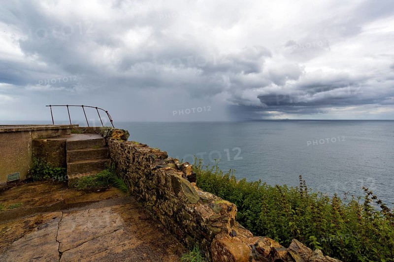 Rain clouds over the sea, coastline between Ballycastle and Ballintoy, viewpoint, Causeway Coastal Route, Antrim, Northern Ireland, Great Britain
