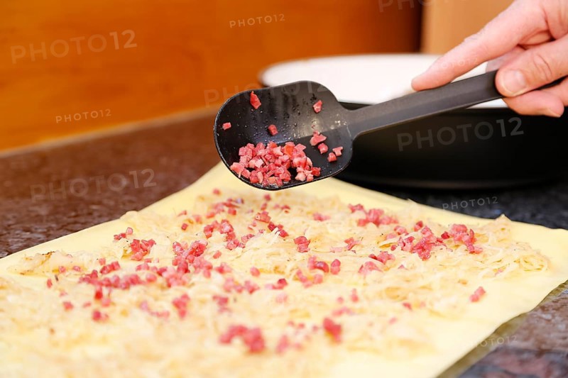Swabian cuisine, preparation of Krautkrapfen, Swabian Mehlsäck, raw pasta pancakes filled with smoked meat, sauerkraut, hearty, savoury, main course, grandmother's cooking, regional, home cooking, typical Swabian, traditional cuisine reinterpreted, men's hands, food photography, studio, Germany, Europe