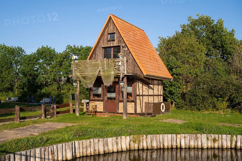 House with hanging fishing nets on the Achterwasser, Ückeritz, Usedom Island, Baltic Sea, Mecklenburg-Western Pomerania, Germany, Europe