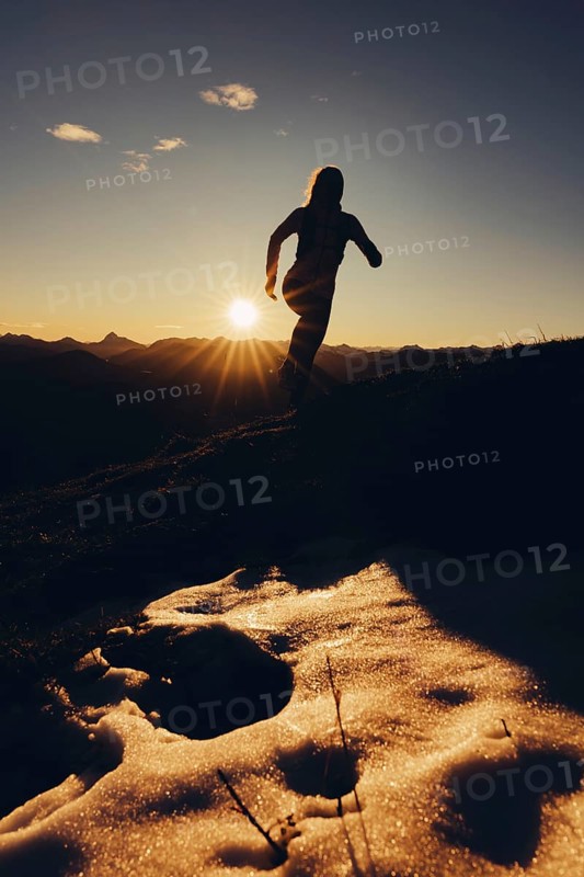 Trail running in autumn on the Jochberg on Lake Walchensee against the wonderful backdrop of the Alps, Bavaria, Germany, Europe