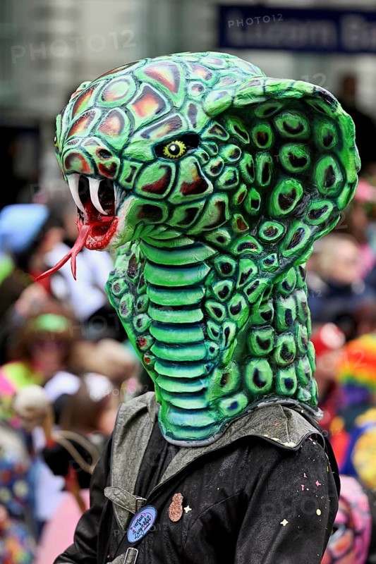 Person masked as a snake head at the carnival parade of the Wey guild on Rose Monday, Güdismäntig, Lucerne Carnival 2024, Lucerne, Switzerland, Europe