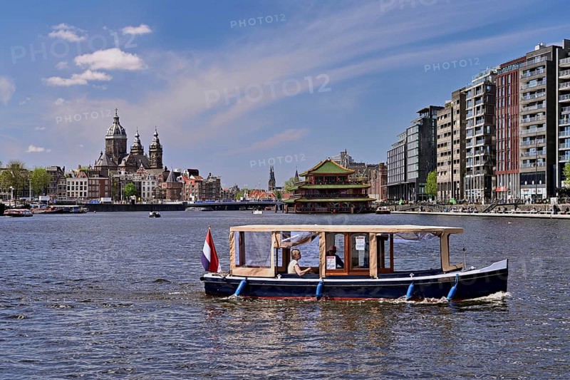 Basilica of St Nicholas (Dutch: Sint-Nicolaasbasiliek), Roman Catholic church with Neo-Baroque and Neo-Renaissance elements, in the foreground a ship on a canal, Amsterdam, Province of North Holland, Netherlands