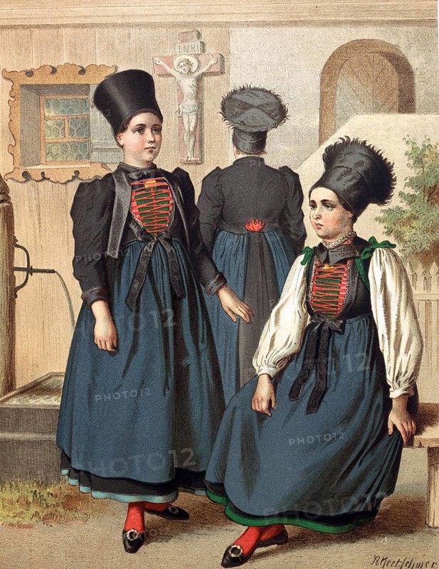 Traditional costumes in Germany around 1820, Vorarlberg, Montafon, Three woman in Tyrolean costumes with striking headgear in front of a house, digitally retouched reproduction of a model from around 1850, by Albert Kretschmer (27 February 1825, 11 July 1891), German painter and traditional costume expert