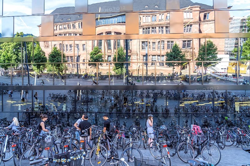 Bicycles parked in front of the reflecting facade of the University Library Freiburg im Breisgau, Black Forest, Baden-Württemberg, Germany, Europe