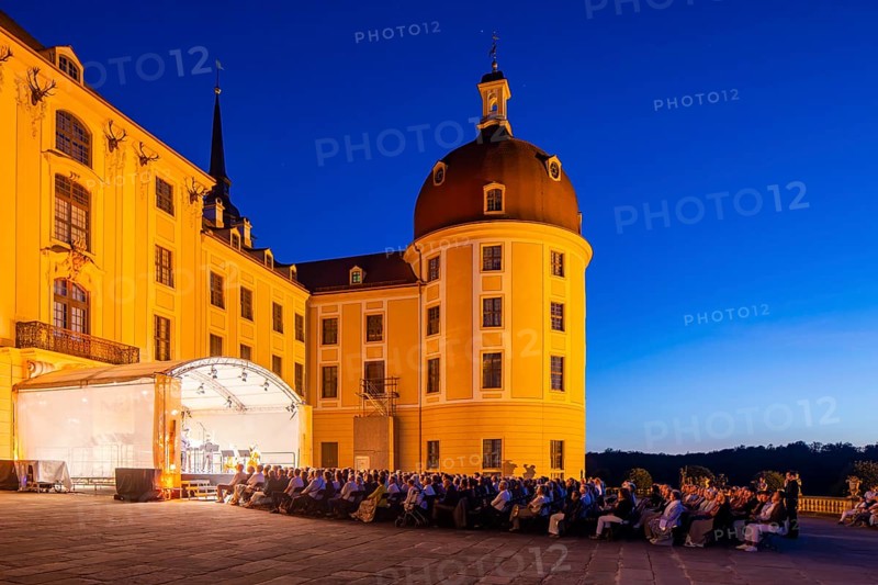 The Moritzburg Festival is an annual chamber music event in Saxony. It was founded in 1993 in Moritzburg by the soloists Kai Vogler, Peter Bruns and Jan Vogler. In Moritzburg, the artists find the ideal setting for the realisation of their musical dreams. The Moritzburg Festival, which has been under the sole artistic direction of cellist Jan Vogler since 2001, has long since established itself internationally as one of the most important festivals for chamber music thanks to its exceptional quality. Here is an evening concert on the north terrace of the baroque palace, Moritzburg Chamber Music Festival, Moritzburg, Saxony, Germany, Europe