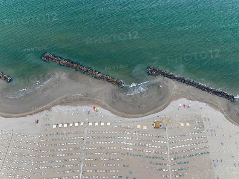 Bathing beach in Rimini. Bathing beach on the Adriatic in bad weather. All deckchairs are free. Drone photo. Rimini, Province of Rimini, Italy, Europe