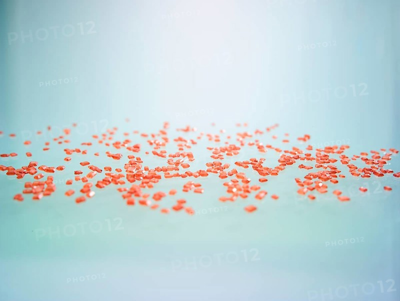 Red-coloured rock candy as a sprinkle decoration for decorating ice cream, cakes and muffins, studio photo