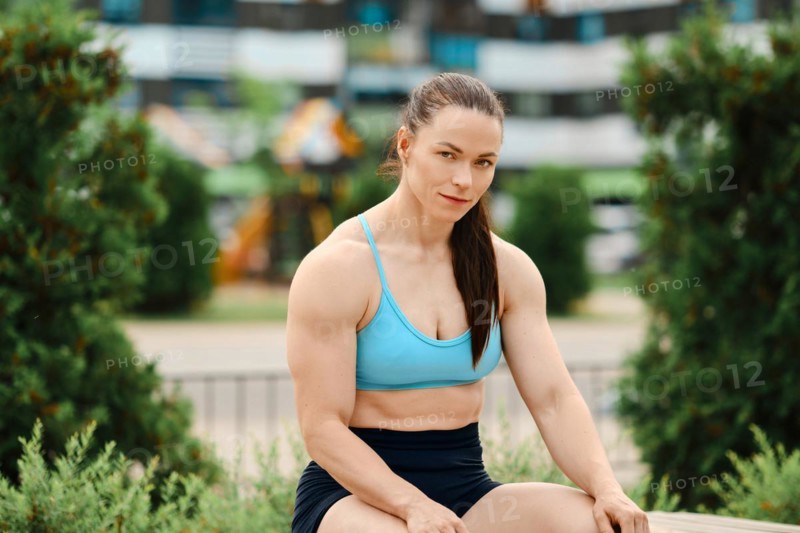 Portrait of athletic muscular woman outdoors