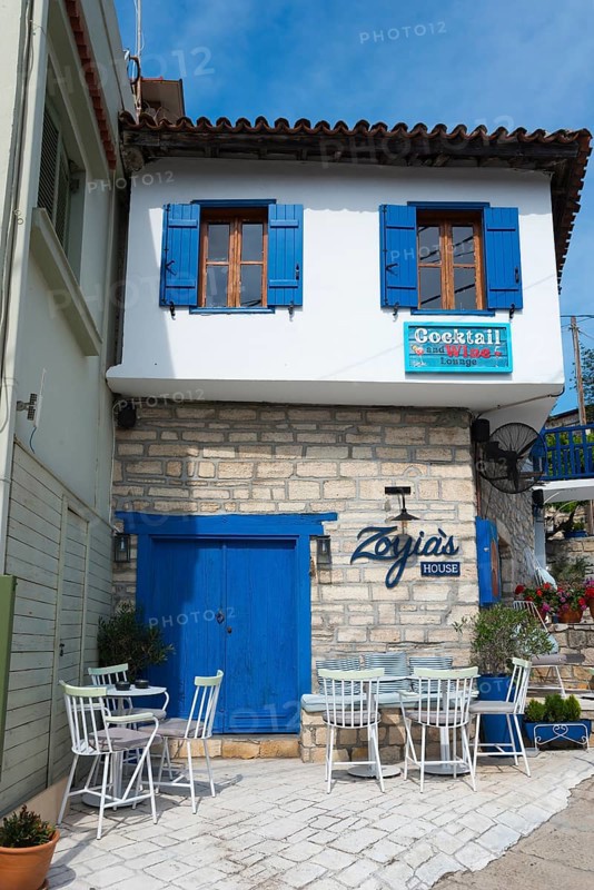 Mediterranean house façade with blue accents and terrace with white furniture under a slightly cloudy sky, Afytos, Afitos, Athitos, Kassandra peninsula, Chalkidiki, Halkidiki, Greece, Europe