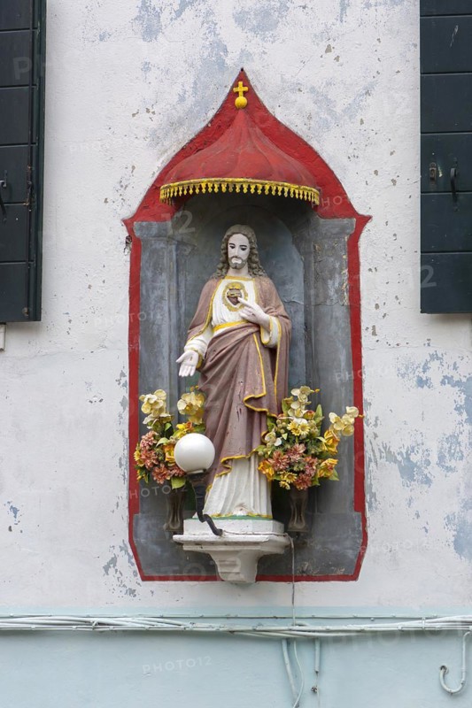 Chistus figure under a canopy on a house, Burano, Veneto, Italy, Europe