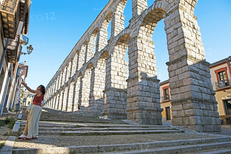Castilian woman pose for a selfie at the Roman aqueduct, Segovia, Segovia province, Castile and Leon, Spain, Europe
