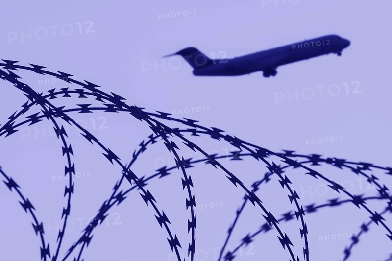 Symbolic image, deportation flights of illegal and delinquent migrants, passenger aircraft, airport, security fence, barbed wire, Germany, Europe
