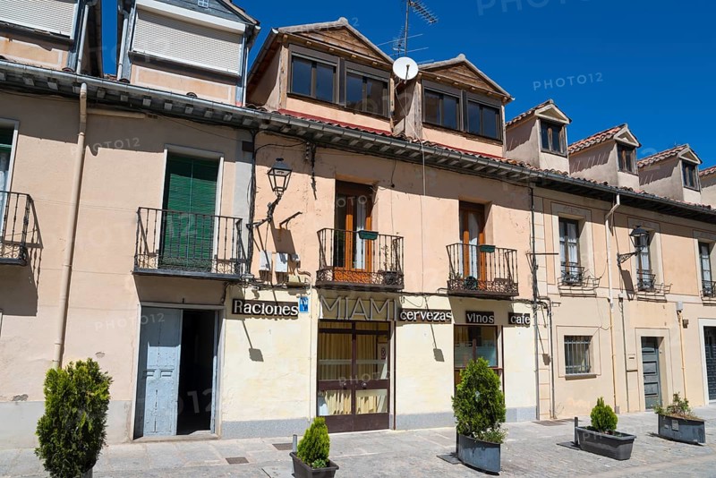 Sunny street scene with buildings, balconies and signs in a Spanish town, Calle de Jose Costa, San Ildefonso, Segovia, Castilla y Leon, Castilla y León, Spain, Europe