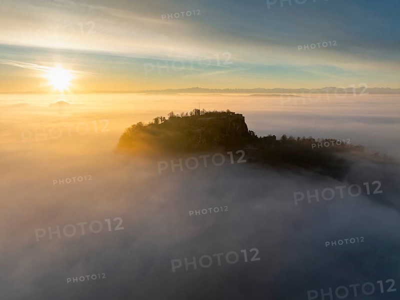 Aerial view of the Hegau volcano Hohentwiel with the upper fortress ruins as a silhouette at sunrise, rising out of the fog during an inversion, district of Constance, Baden-Württemberg, Germany, Europe