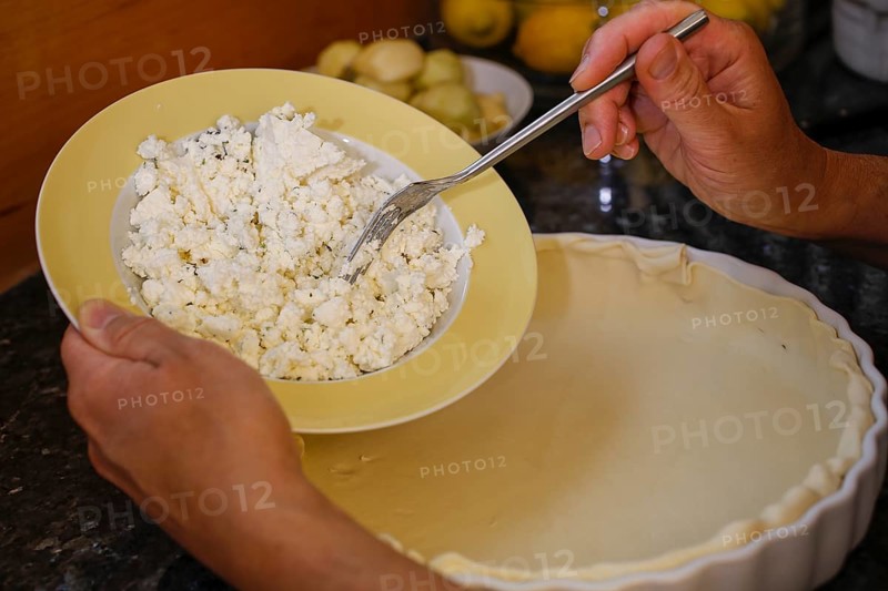 Stuttgart Gaishirtle, pear variety, fruit, preparation of tart with Gaishirtle and sheep's cheese, cheese in tart tin with dough, fork, baking, typical Swabian, Swabian cuisine, traditional cuisine reinterpreted, vegetarian, men's hands, food photography, studio, Germany, Europe